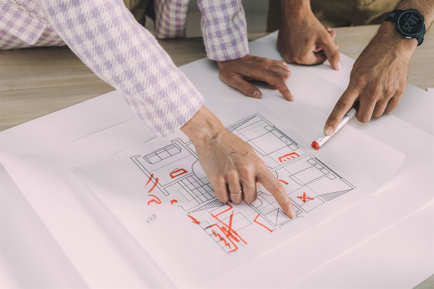 Advisors marking up an apartment floor plan