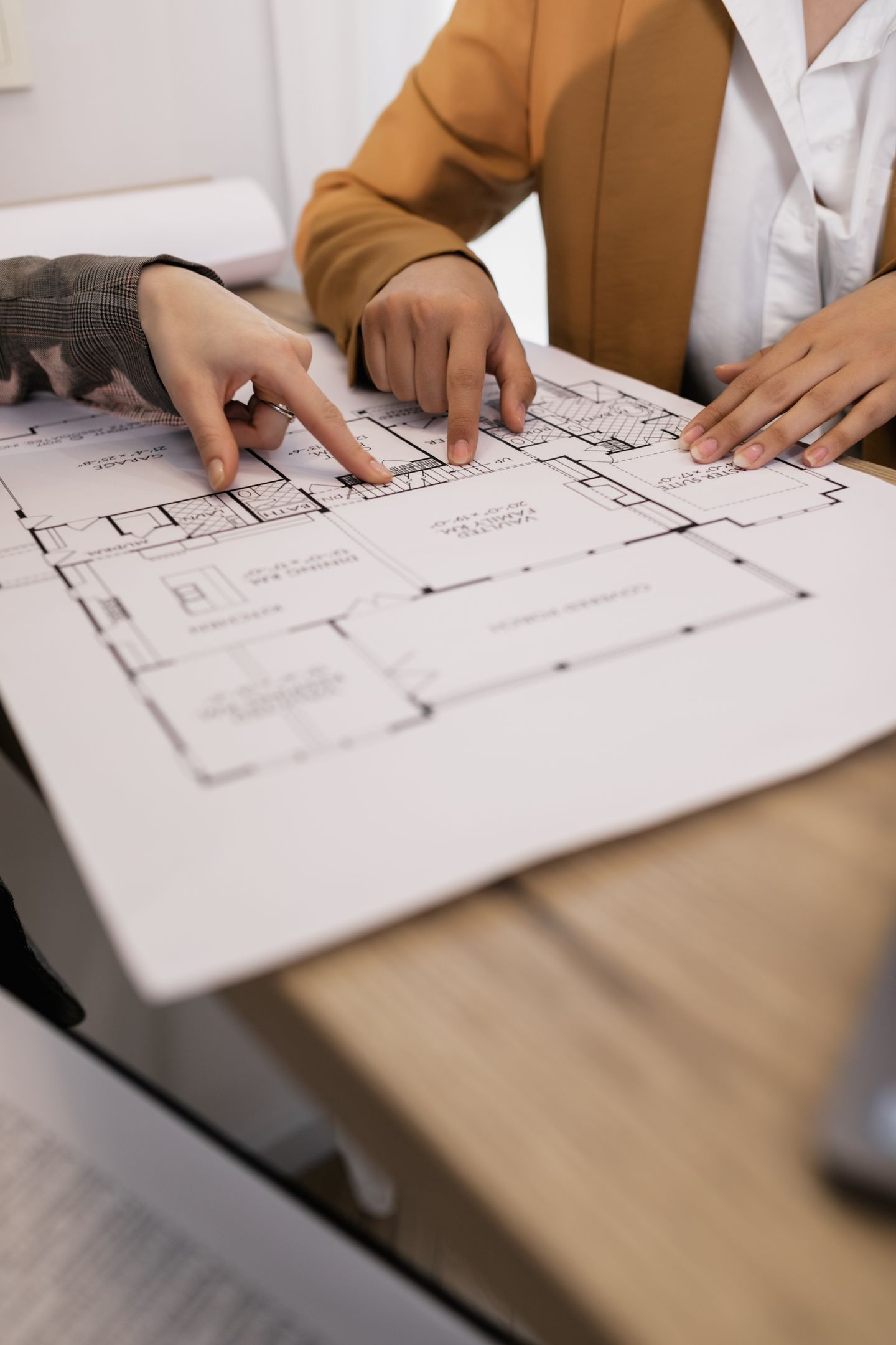 Two people discussing a property floor plan together